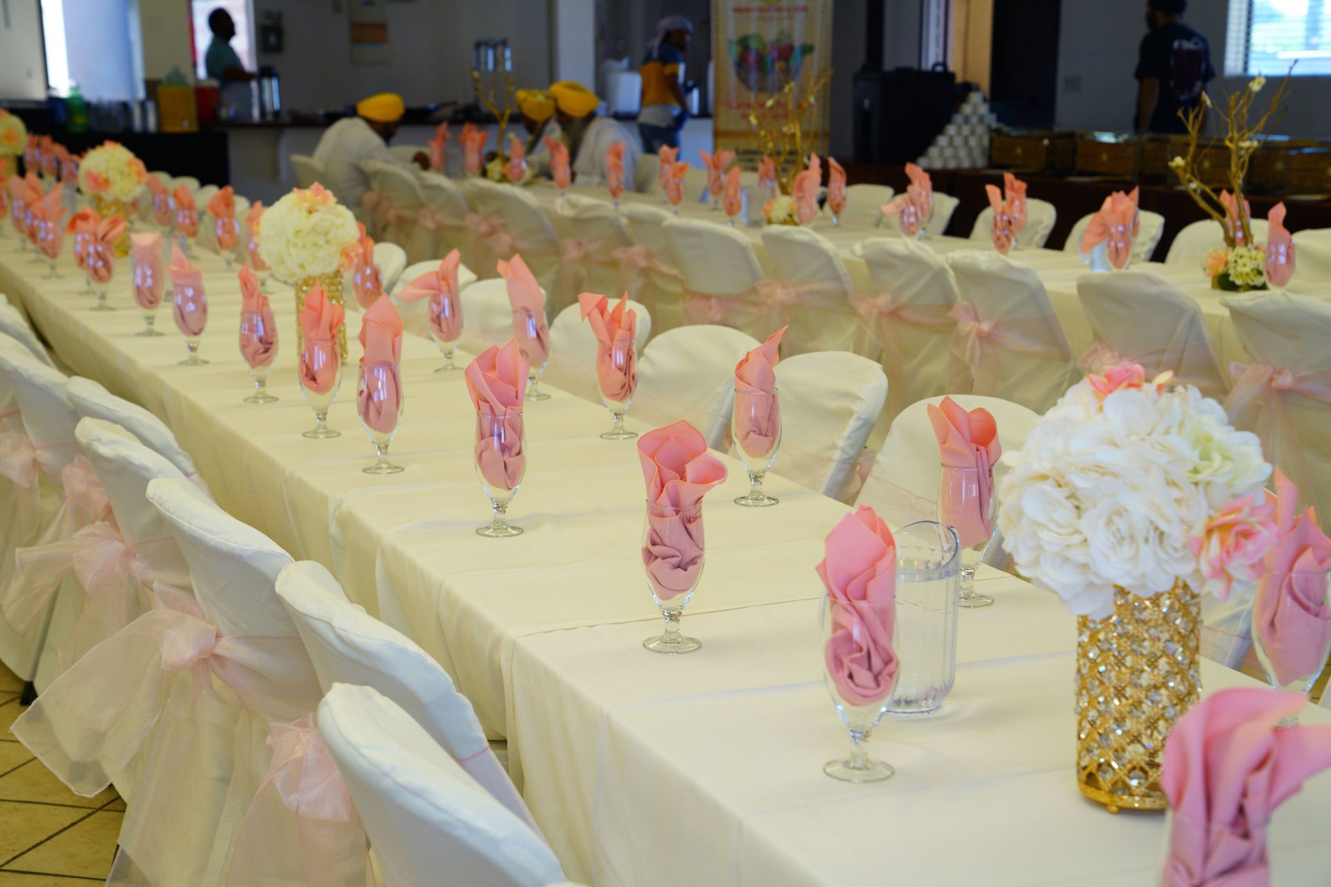 Set long banquet tables in white and pink colors arranged in modern restaurant for wedding celebration