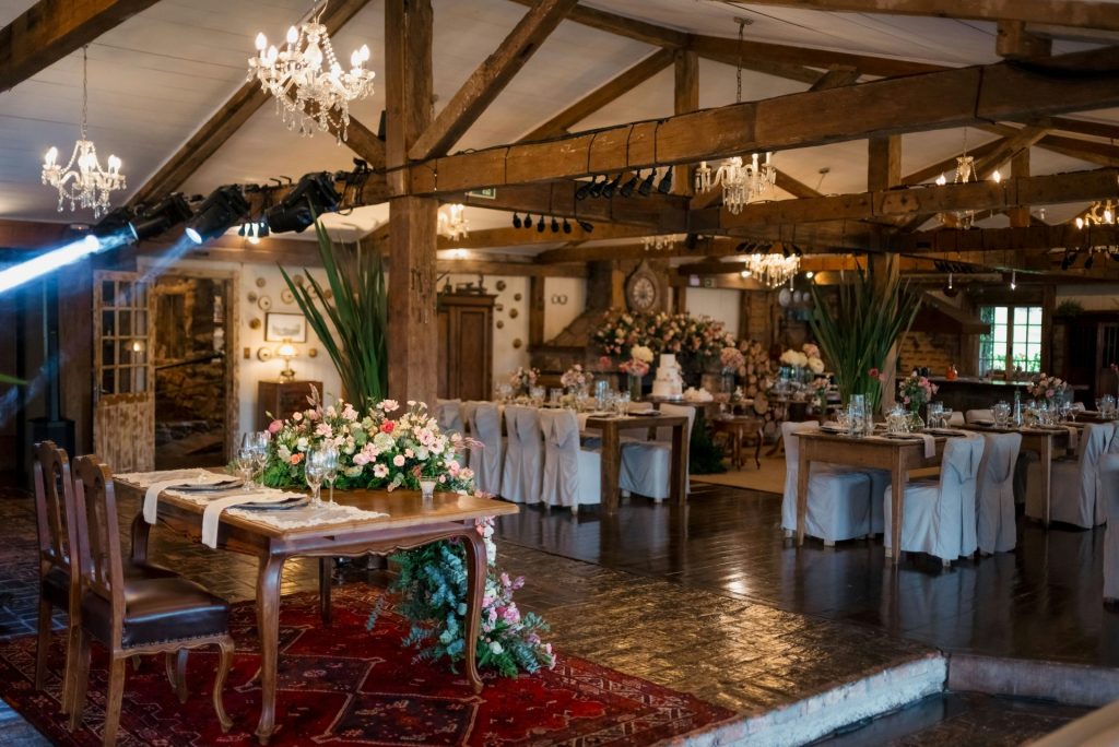 Elegant event hall decorated with flowers and wooden beams